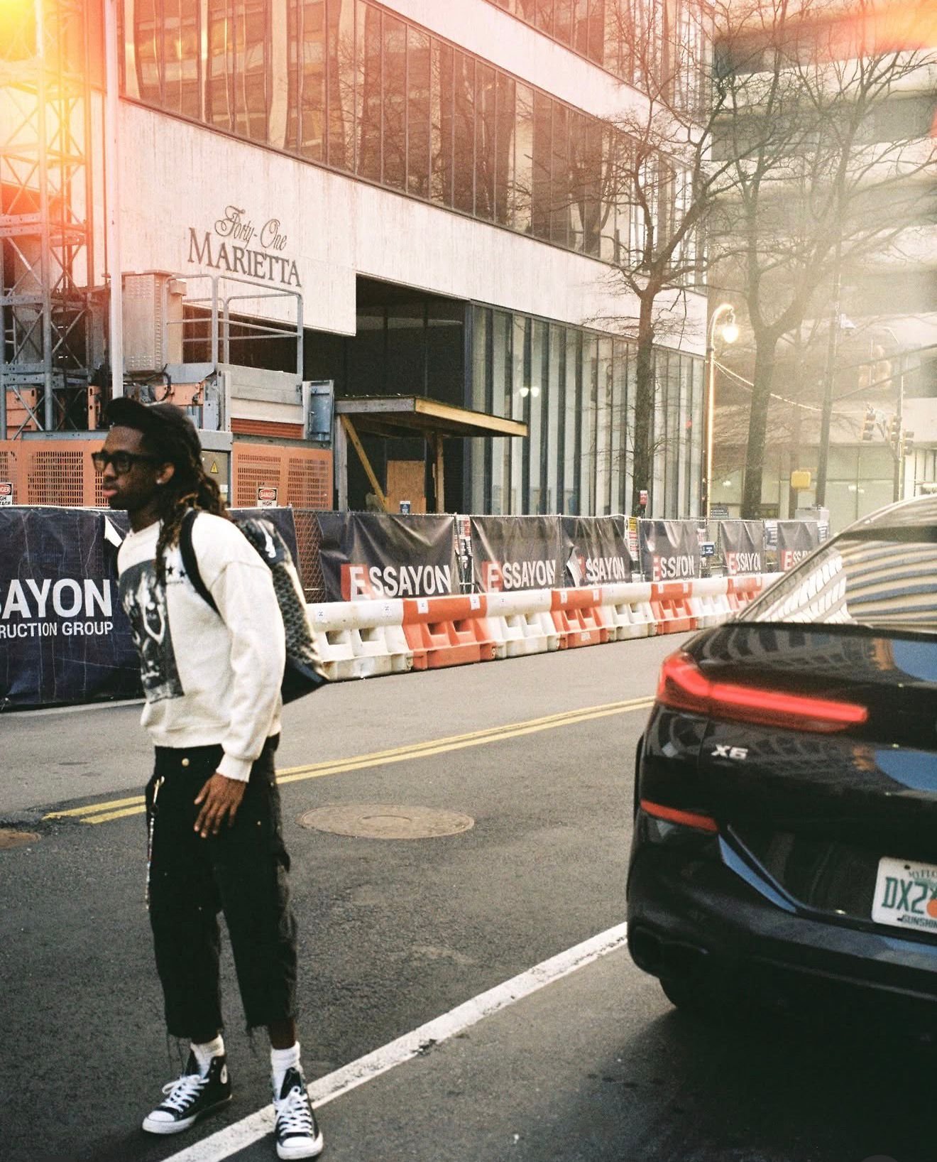 Crewneck and cargos crossing a city street at golden hour