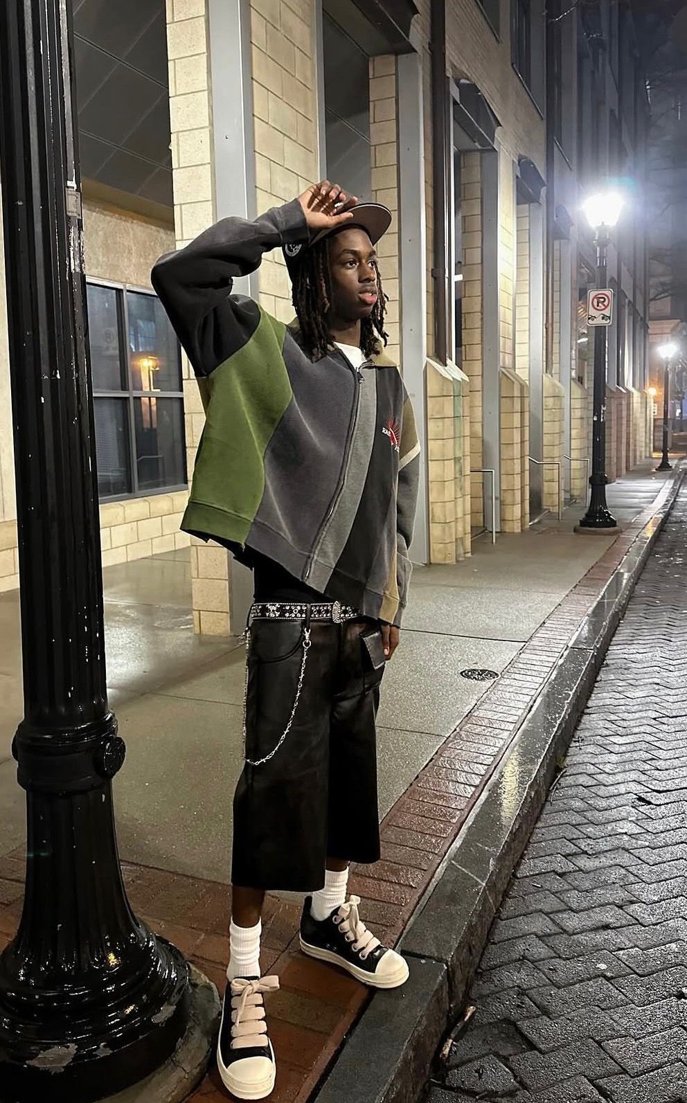 Color-block zip-up jacket on a rainy night street