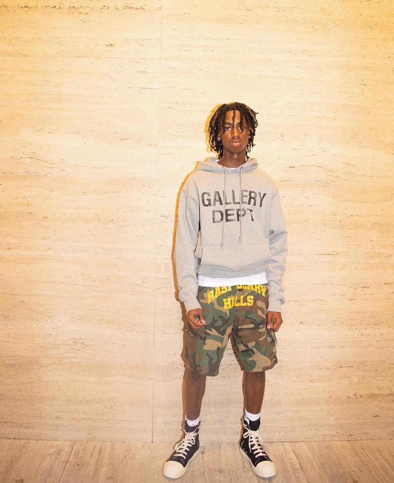 Gallery Dept hoodie look against a travertine wall